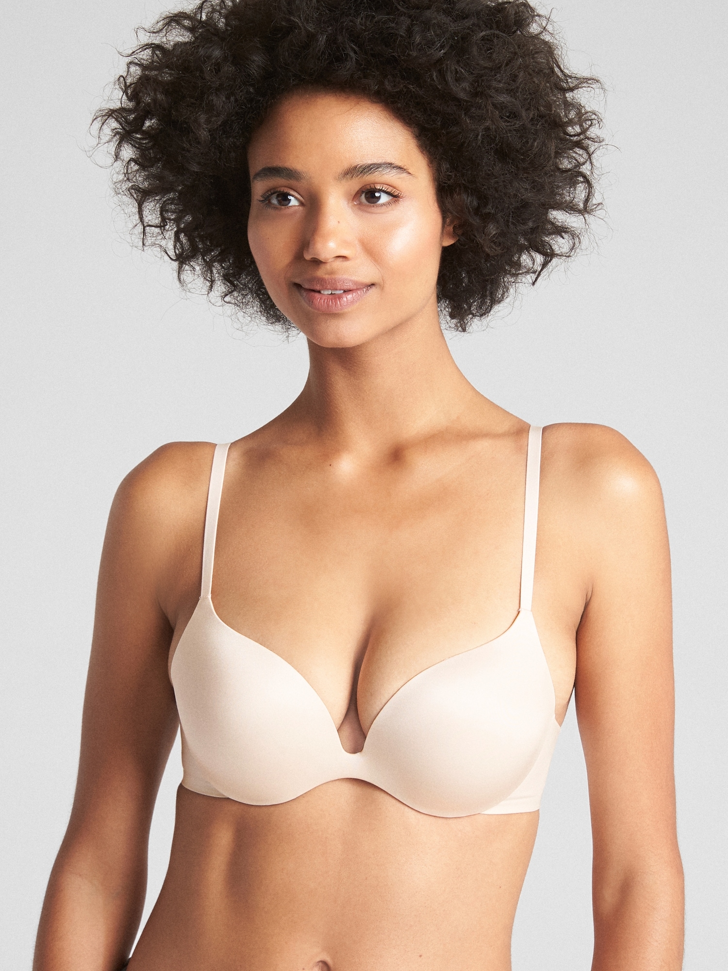 Woman in white push up bra on gray background, perfect female breast Stock  Photo