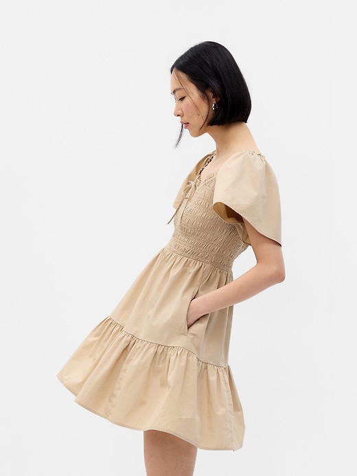 Image number 1 showing, Flutter Sleeve Smocked Mini Dress